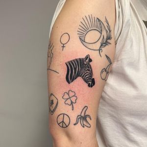 Black and gray zebra tattoo created by Tas Kal, featuring detailed illustration work.