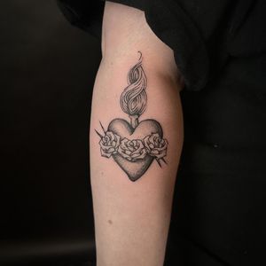 Experience the beauty of a black and gray sacred heart tattoo, expertly crafted by the talented artist Jenny Dubet.