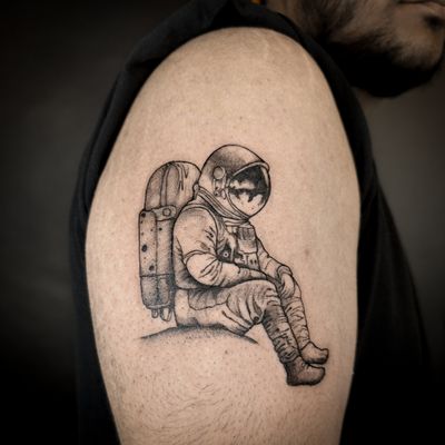 Explore the cosmos with this intricate illustrative astronaut tattoo by talented artist Jenny Dubet.