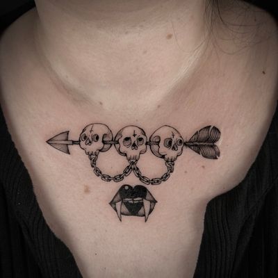 A stunning blackwork illustrative tattoo featuring a skull, arrow, and lips, expertly done by tattoo artist Jenny Dubet.