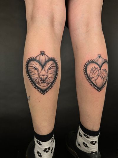 Adorable illustrative tattoo featuring a cat, heart, and pet paw, showcasing the unbreakable bond between pets and their owners. Done by the talented artist Jenny Dubet.