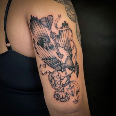 Beautifully designed tattoo with bird, flower, heart, and arrow motifs by Jenny Dubet. Perfect for nature lovers.