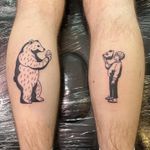 Illustrative tattoo by Dave Norman featuring a bear, a kid, and a mask motif. Bold and detailed blackwork design.