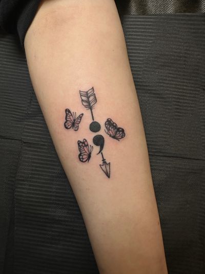 Beautiful tattoo combining a butterfly, arrow, and semi colon by talented artist Jenny Dubet.