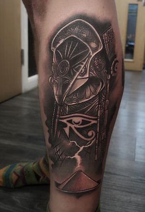 Capture the divine energy of Horus with this captivating black and gray Egyptian tattoo by renowned artist Craig Hicks.