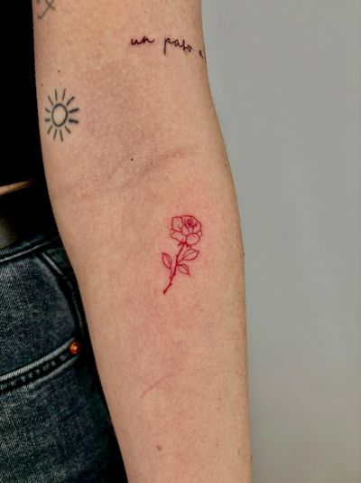 Elegantly detailed red rose in fine line style by Ruth Hall, a stunning addition to your body art collection.
