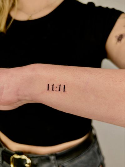 Get a delicate and personalized small lettering tattoo by the talented artist Ruth Hall. Perfect for a subtle and meaningful design.
