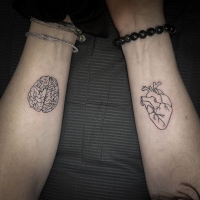 Get a unique illustrative tattoo of a heart and brain intertwined, created with precision by talented artist Jenny Dubet.