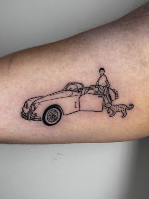 Exquisite illustrative tattoo by Jonathan Glick featuring a powerful woman, majestic cheetah, and stylish car design.
