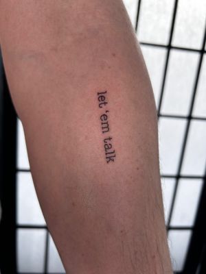 Get a unique small lettering tattoo by Jonathan Glick for a minimalist and personalized touch to your body art. Perfect for expressing meaningful words or phrases.