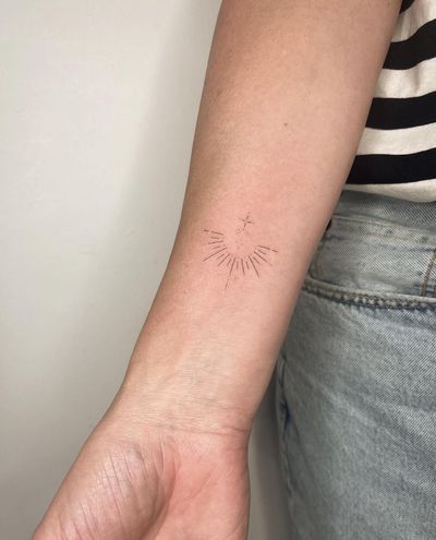 Embrace your inner sparkle with this dainty fine line star tattoo, expertly crafted by the talented artist Amelia.