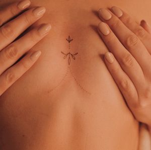 Unleash your inner elegance with this fine_line hand_poke tattoo designed by Anna. Embrace the delicate and dainty motif for a truly unique and timeless piece.
