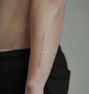 Get a beautifully delicate tattoo with tiny lettering done by Amelia, perfect for a subtle and elegant look.