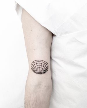 Explore the depths of the universe with this fine line geometric tattoo featuring a blackhole and wormhole motif. Designed by the talented artist Malvina Maria Wisniewska.
