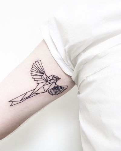 Explore the delicate beauty of this fine line geometric bird tattoo by the talented artist Malvina Maria Wisniewska. Perfect for those who appreciate intricate designs.