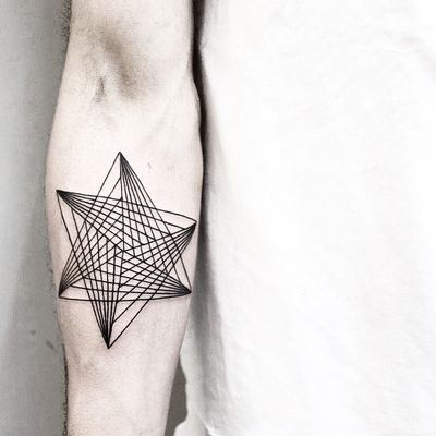 Explore intricate patterns in this fine line tattoo by Malvina Maria Wisniewska, featuring a stylish geometric triangle motif.