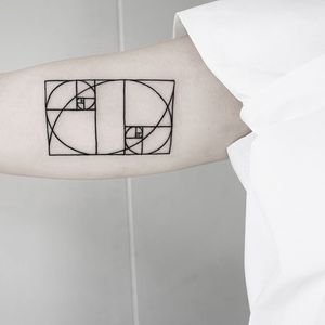 Experience the timeless beauty of the golden ratio and fibonacci spiral in this fine line geometric tattoo by Malvina Maria Wisniewska.