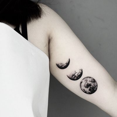 This stunning tattoo by Malvina Maria Wisniewska showcases the different phases of the moon in intricate black & gray dotwork style.