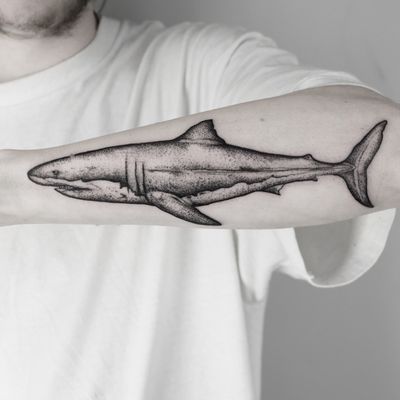 Get a unique black and gray dotwork shark tattoo by the talented artist Malvina Maria Wisniewska. Dive into her intricate design and fierce detail.