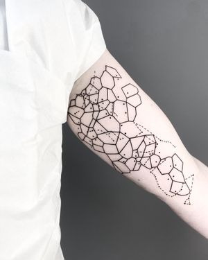 Discover the beauty of fine line and geometric designs with this elegant map tattoo by Malvina Maria Wisniewska.