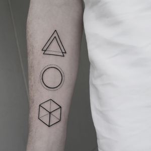 Experience the intricate beauty of a geometric tattoo featuring a circle, triangle, and cube, designed by Malvina Maria Wisniewska.