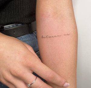 Get a delicate and intricate fine line tattoo with small lettering by the talented artist Amelia. Perfect for a minimalist look.