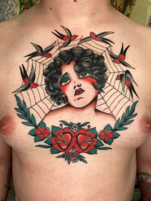 Stunning traditional tattoo featuring a swallow, rose, lady, and web, expertly done by Ryan Goodrum.