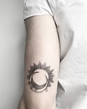 Experience the harmony of sun and moon in this stunning blackwork, fine line, geometric tattoo by Malvina Maria Wisniewska.