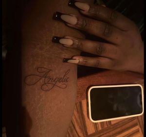Fine line and small lettering tattoo by Sophia Hayes, perfect for dark skin tones.