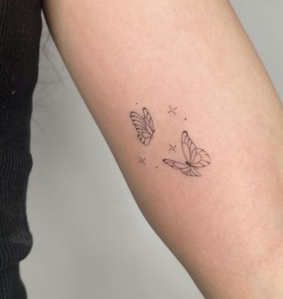 Explore the delicate beauty of fine line and illustrative style with this stunning butterfly tattoo by the talented artist Amelia.