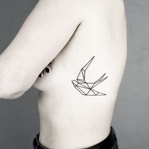 Elegant fine line tattoo of a swallow bird in geometric style by Malvina Maria Wisniewska. Perfect for minimalistic tattoo lovers.