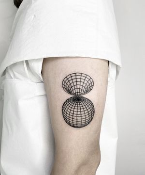 Explore a cosmic journey with this fine line tattoo by Malvina Maria Wisniewska, featuring a mesmerizing globe design intertwined with a futuristic wireframe and wormhole motif.