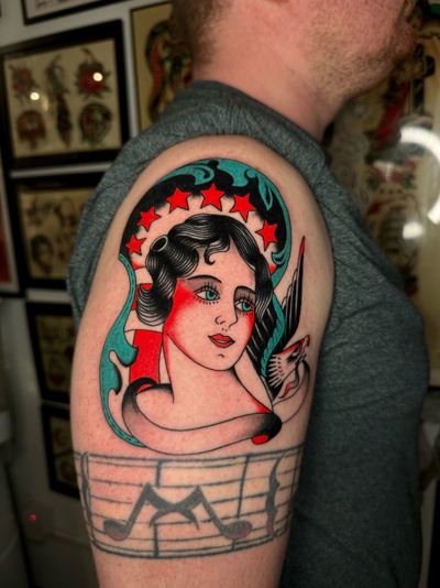 Beautiful traditional tattoo featuring an eagle and a lady, expertly executed by Ryan Goodrum.