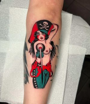 Get inked with a fierce lady pirate in classic traditional style by Ryan Goodrum.