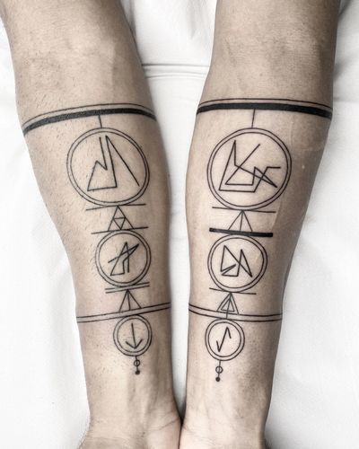 Blackwork tattoo by Malvina Maria Wisniewska featuring intricate geometric symbols in a band design.