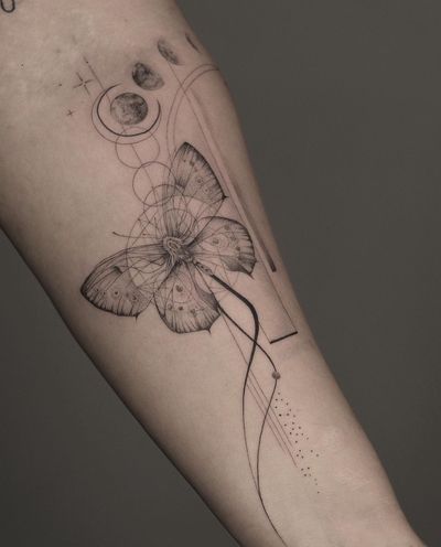 Beautiful black and gray fine line tattoo by Kayla featuring a geometric design with a moon and butterfly motif.