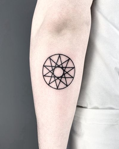 Unique tattoo by Malvina Maria Wisniewska featuring a fine line, geometric design with a star and circle motif.