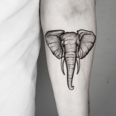 A beautifully detailed and illustrative black & gray elephant tattoo created by the talented artist Malvina Maria Wisniewska.