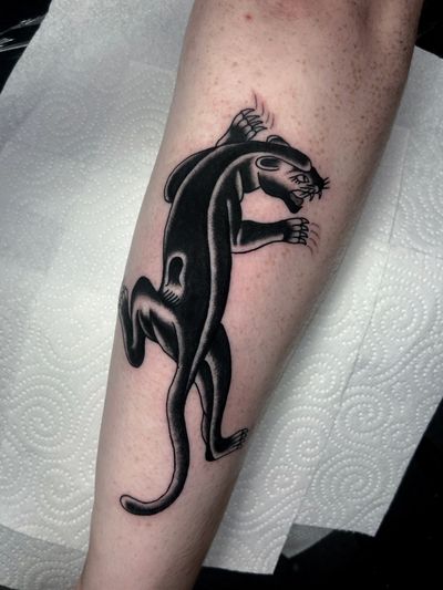 Capture the fierce and powerful essence of the panther with this striking traditional style tattoo by the talented artist Ryan Goodrum.