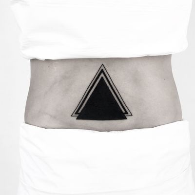 Get a sleek and modern look with this blackwork tattoo featuring a bold geometric triangle design by Malvina Maria Wisniewska.