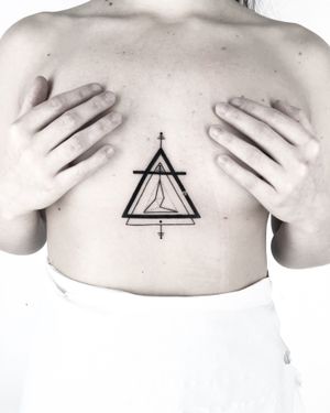Explore the bold lines and intricate patterns of this stunning blackwork triangle tattoo by Malvina Maria Wisniewska.