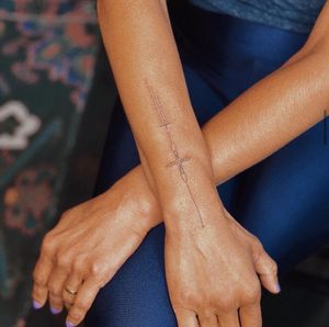 Experience intricate details and delicate artistry with this fine line hand poke tattoo designed by the talented artist, Anna, on dark skin tones.
