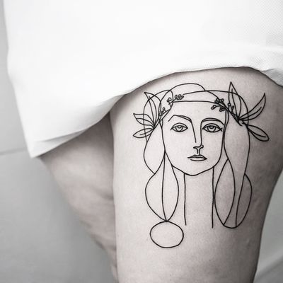 Experience the artistry of Malvina Maria Wisniewska with this fine line illustrative tattoo of a beautiful woman.