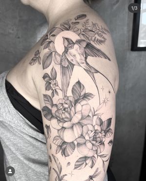 Elegant black and gray illustration combining a swallow and flower, expertly done by tattoo artist Kayla.