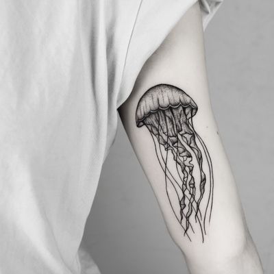 Experience the mesmerizing beauty of a jellyfish rendered in stunning dotwork and fine line style by Malvina Maria Wisniewska.