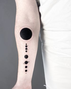 Get lost in the beauty of the cosmos with this stunning blackwork tattoo featuring the planets of our solar system. By artist Malvina Maria Wisniewska.
