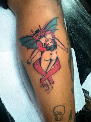 Get bewitched by this stunning traditional tattoo of a seductive succubus designed by the talented artist Ryan Goodrum.