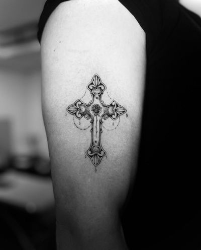 Intricately designed cross tattoo by talented artist Georgina, blending artistry and faith in a unique illustrative style.