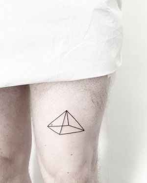 Experience the mystique of ancient Egypt with this fine line and geometric pyramid tattoo by Malvina Maria Wisniewska.