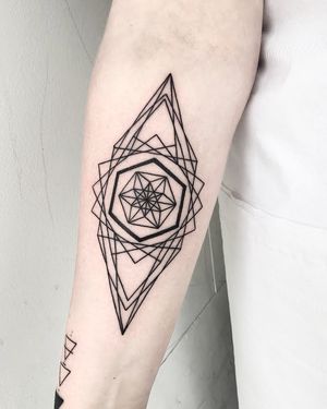 Explore the perfect symmetry and intricate patterns of this stunning geometric tattoo designed by the talented Malvina Maria Wisniewska.